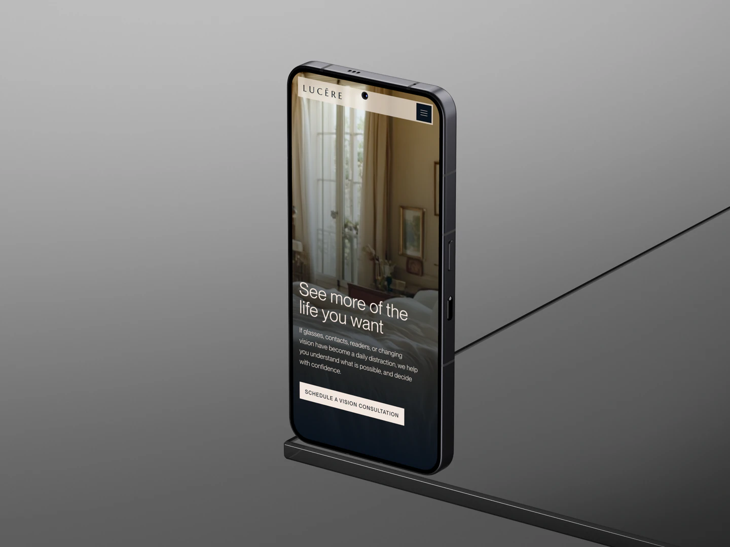 Lucēre Vision homepage displayed on a phone against a gray background