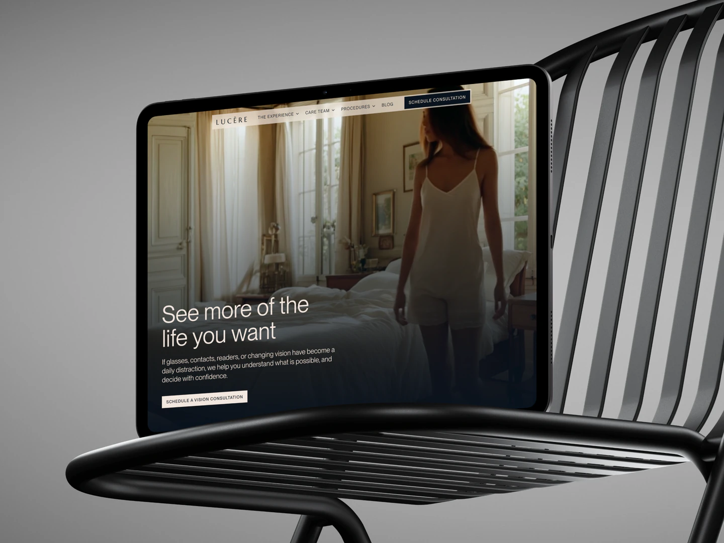 Lucēre Vision homepage displayed on a tablet on a black chair