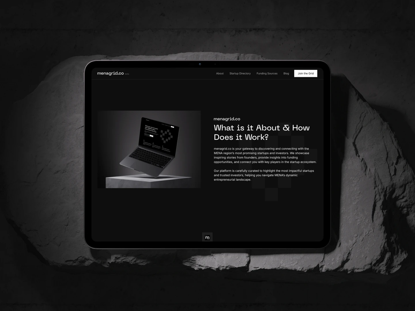 Menagrid platform introduction displayed on a tablet on a stone surface