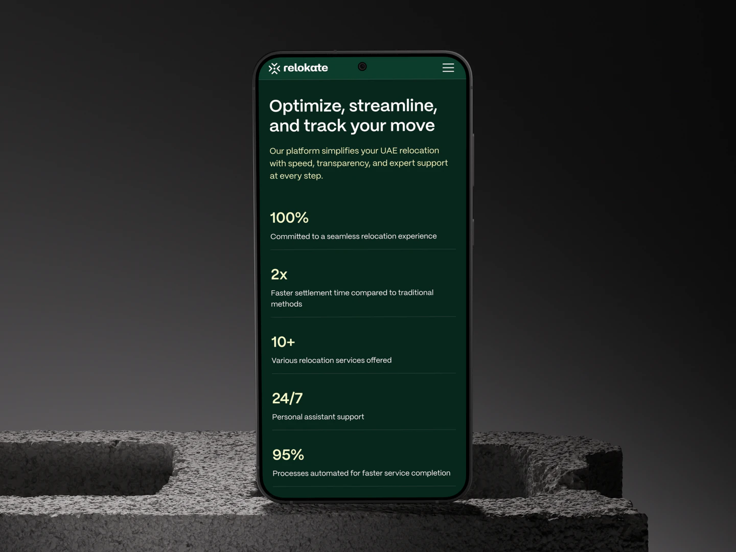 Relokate mobile relocation benefits on a phone resting on concrete blocks