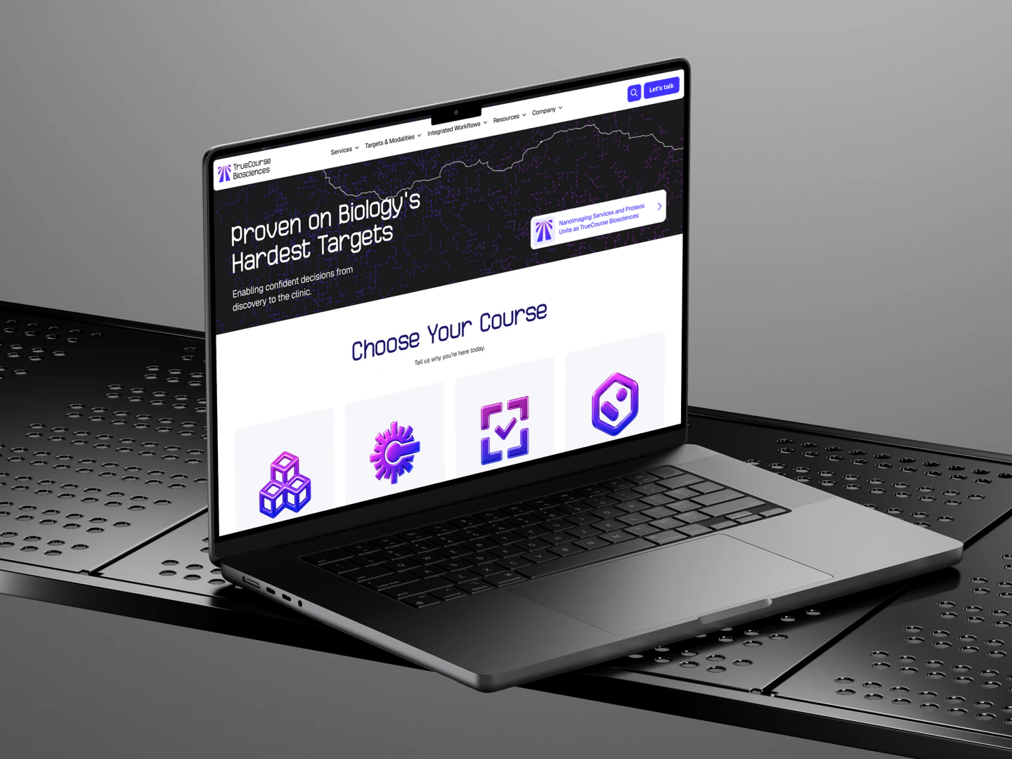 TrueCourse Biosciences homepage displayed on a laptop on a metal bench