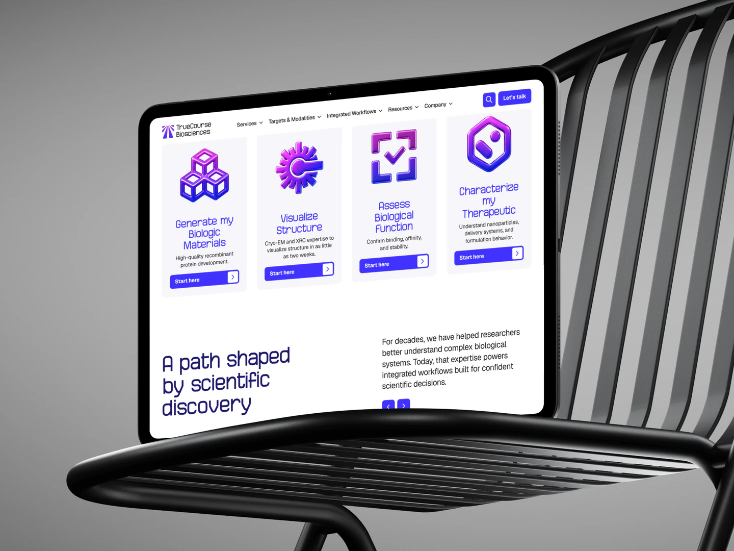 TrueCourse Biosciences services and scientific discovery content displayed on a tablet on a black chair