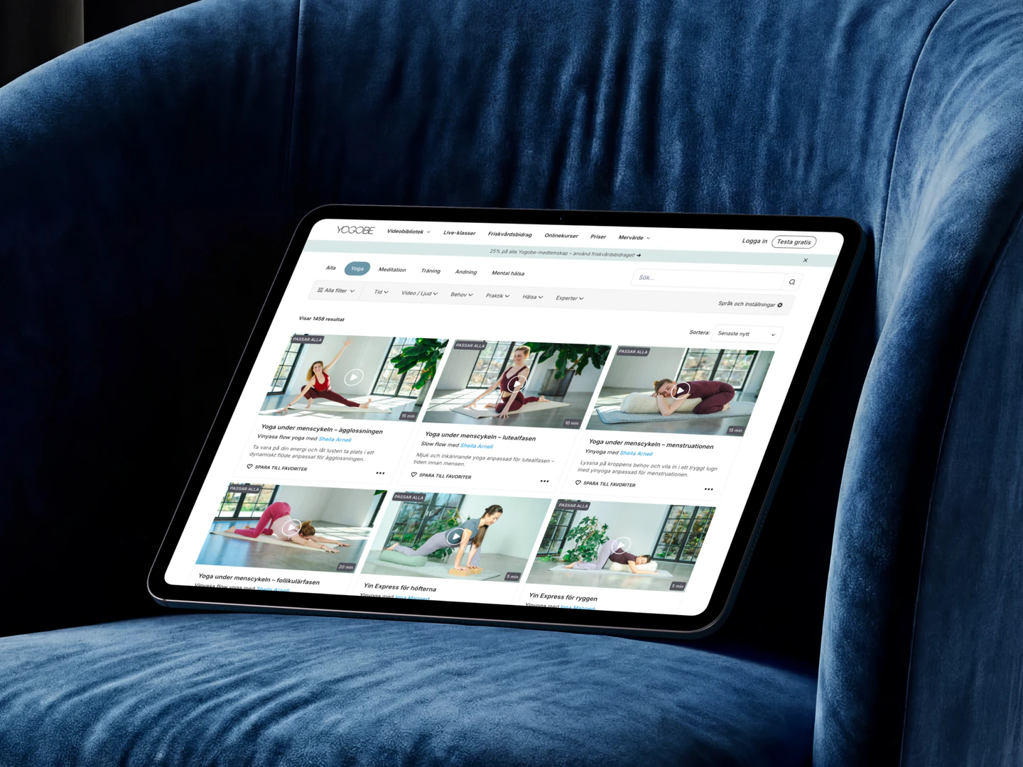Yogobe video library on a tablet resting on a blue armchair